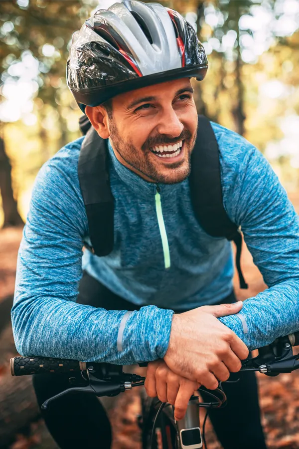 Concussion-Treatment A helmeted cyclist happily sitting on his bike. Get treatment for concussions from Tasmin Cordie, D.C. of Sage Functional Medicine in Marlboro Township.