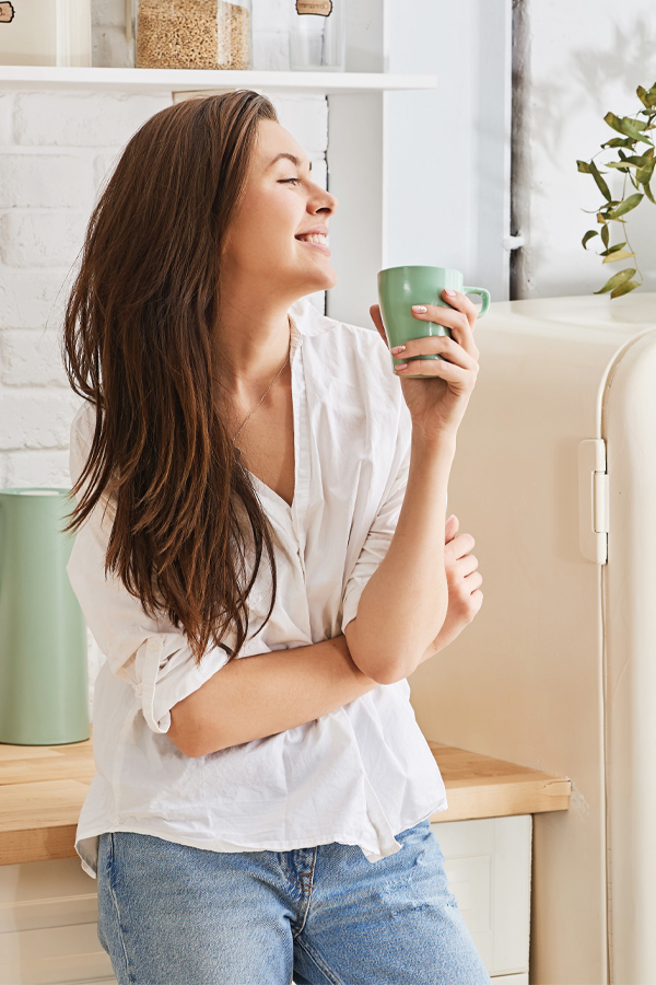 A woman drinks from mug. Get treatment for detoxification challenges from Tasmin Cordie, D.C. of Sage Functional Medicine in Marlboro Township.
