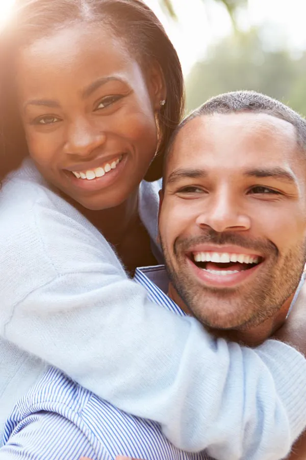 A black couple embrace outside. Get treatment for dizziness from Tasmin Cordie, D.C. of Sage Functional Medicine in Marlboro Township.