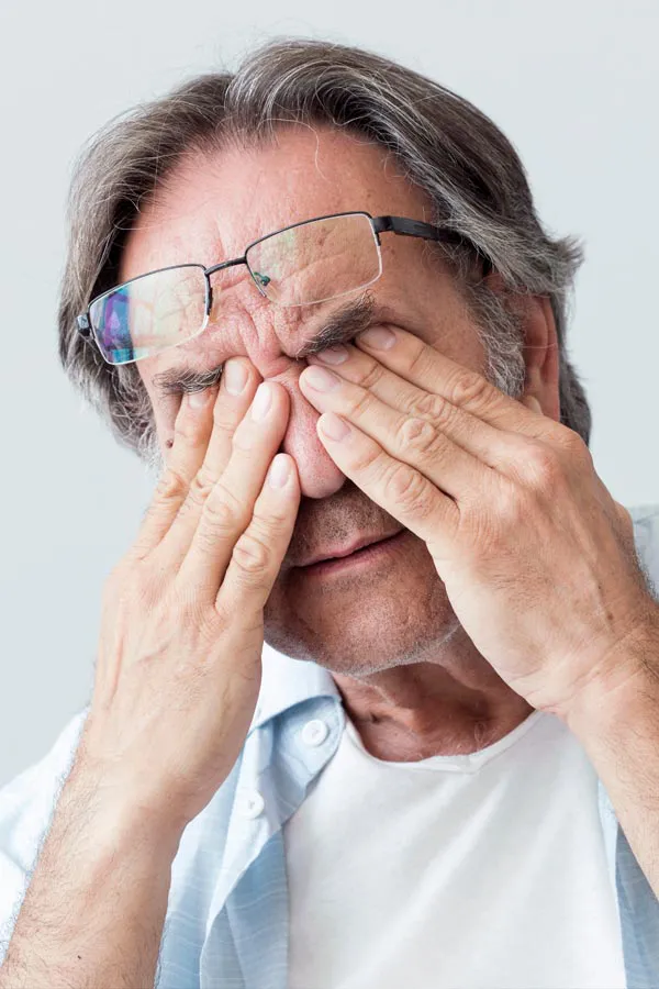 Fatigue-and-Low-Energy-Treatment A middle-aged man pushes his glasses onto his forehead and rubs his eyes with exhaustion. Get fatigue and low energy treatment from Tasmin Cordie, D.C. of Sage Functional Medicine in Marlboro Township.