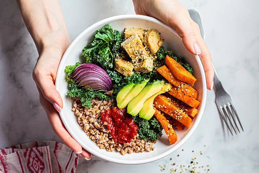 Hands holding a bowl of nutritious foods. Get treatment for nutritional imbalances from Tasmin Cordie, D.C. of Sage Functional Medicine in Marlboro Township.
