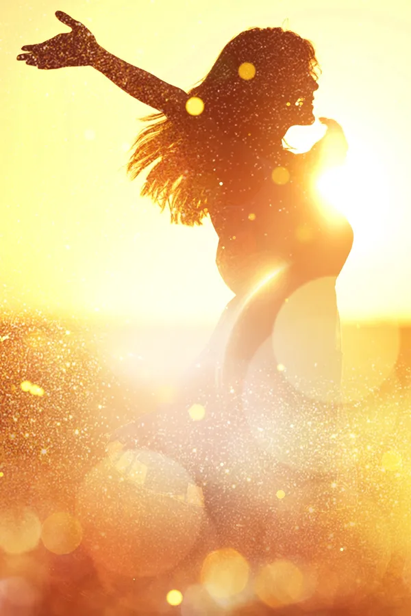 A woman with outstretched arms in a sun-dappled field. Get quantum neurology treatment from Tasmin Cordie, D.C. of Sage Functional Medicine in Marlboro Township.